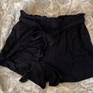 Black “trash-bag” top black shorts